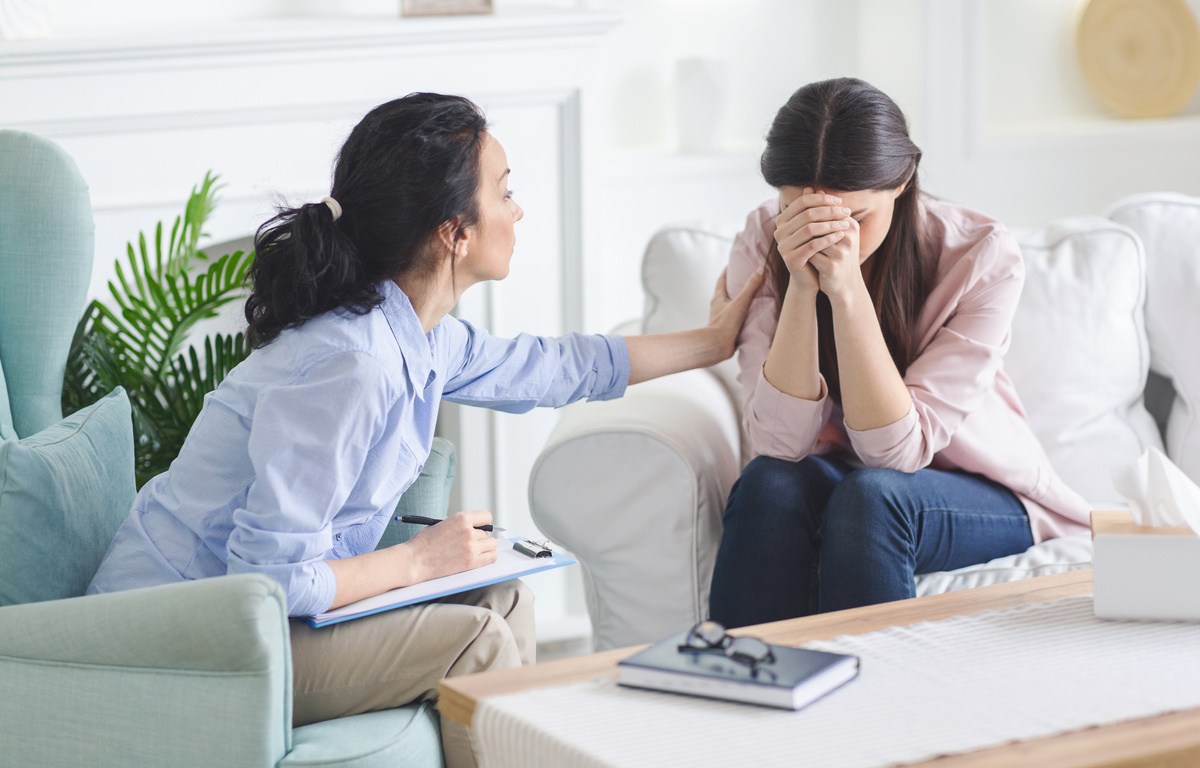 Psychiatrist comforting a patient struggling with treatment-resistant depression during a consultation