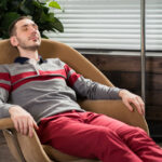 Adult patient resting comfortably in a chair during a supervised Spravato treatment session