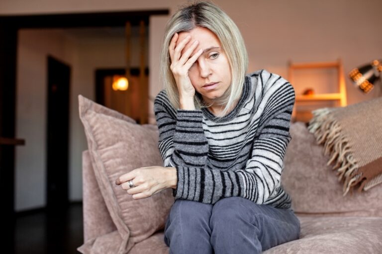 Adult sitting quietly overwhelmed representing the experience of having depression and anxiety at the same time
