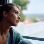 Adult sitting thoughtfully representing the process of understanding the difference between depression and bipolar disorder