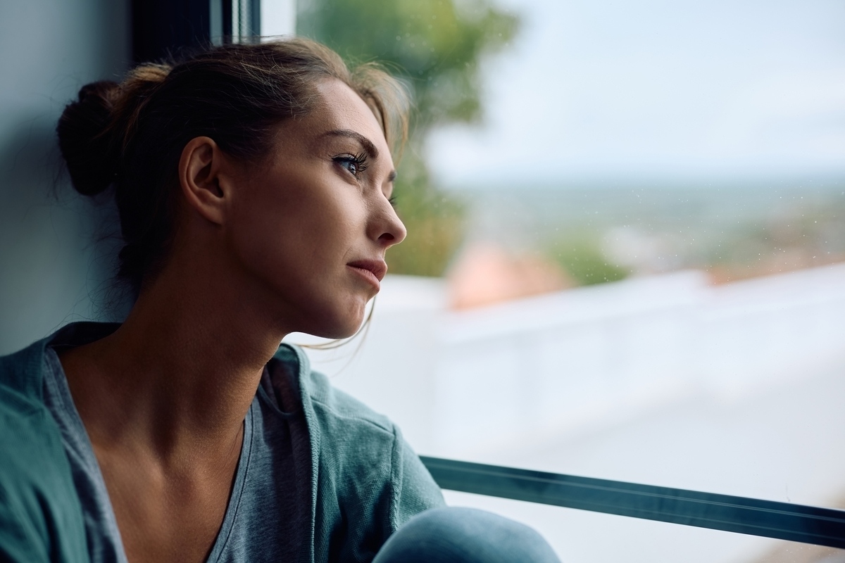 Adult sitting thoughtfully representing the process of understanding the difference between depression and bipolar disorder