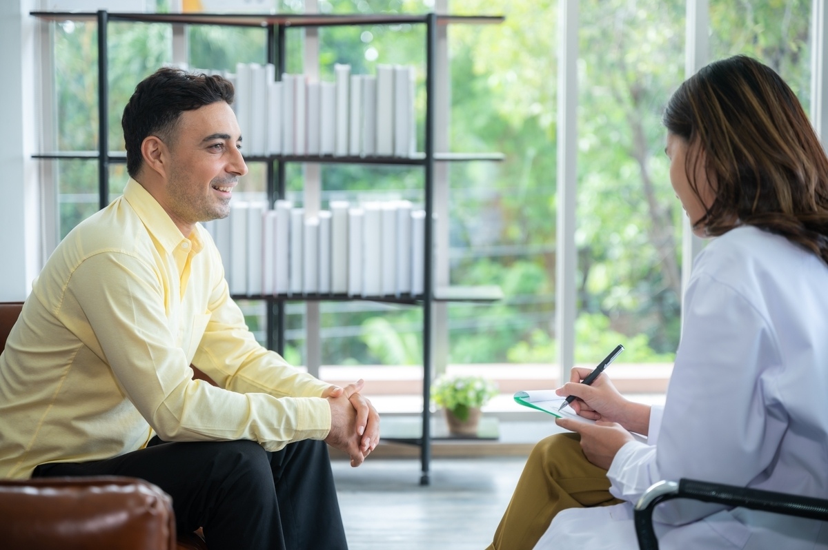 Male patient smiling during psychiatric consultation about treatment resistant depression in Maricopa AZ